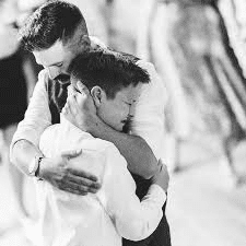 Father and son sharing a special moment outdoors, symbolizing the power of a song for the son.